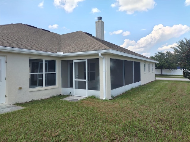 back of property featuring a lawn