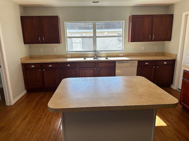 kitchen with dishwasher, a kitchen island, dark wood-type flooring, and sink