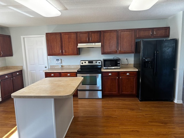 kitchen featuring a center island, dark hardwood / wood-style flooring, a textured ceiling, and appliances with stainless steel finishes