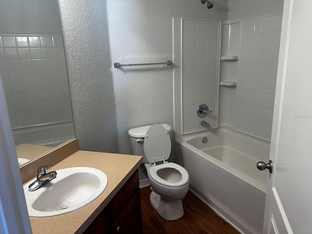 full bathroom with vanity, hardwood / wood-style flooring, toilet, and shower / washtub combination