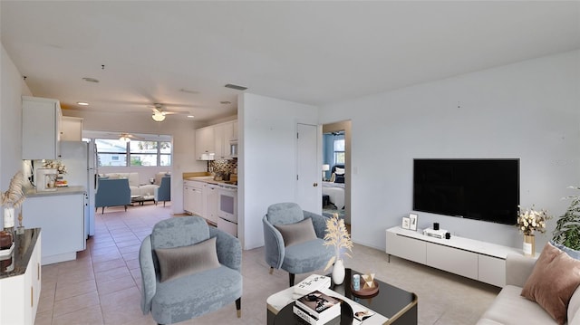 tiled living room with ceiling fan