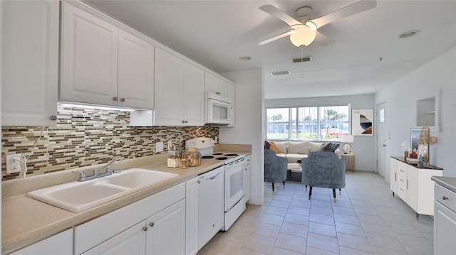 kitchen featuring ceiling fan, sink, light tile patterned floors, white appliances, and white cabinets