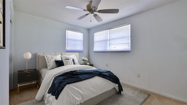 bedroom featuring light carpet and ceiling fan