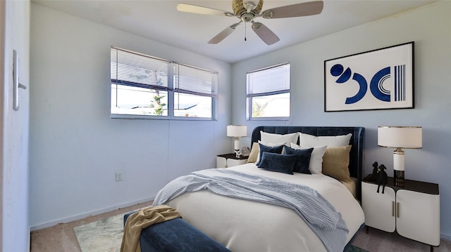 carpeted bedroom with multiple windows and ceiling fan