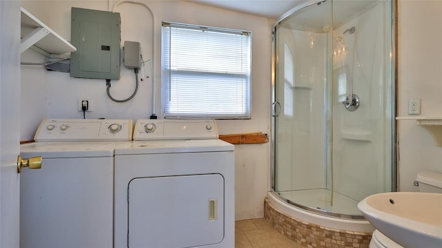 washroom featuring independent washer and dryer, light tile patterned floors, and electric panel