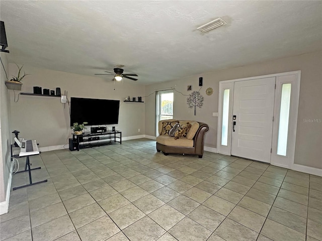 tiled living room with ceiling fan