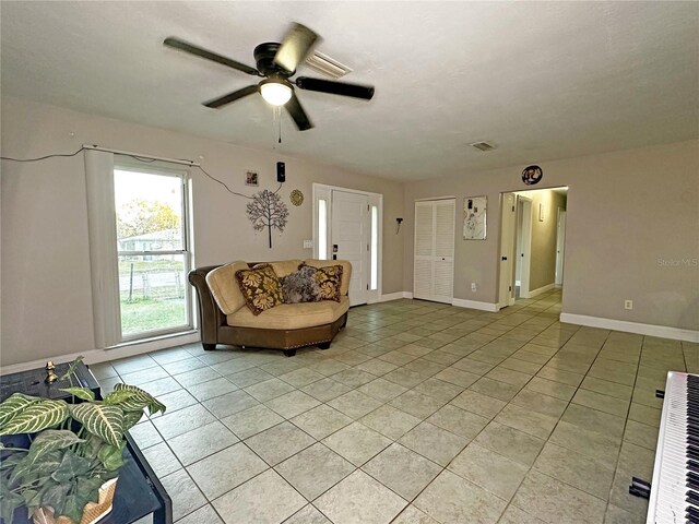 sitting room featuring light tile patterned floors and ceiling fan