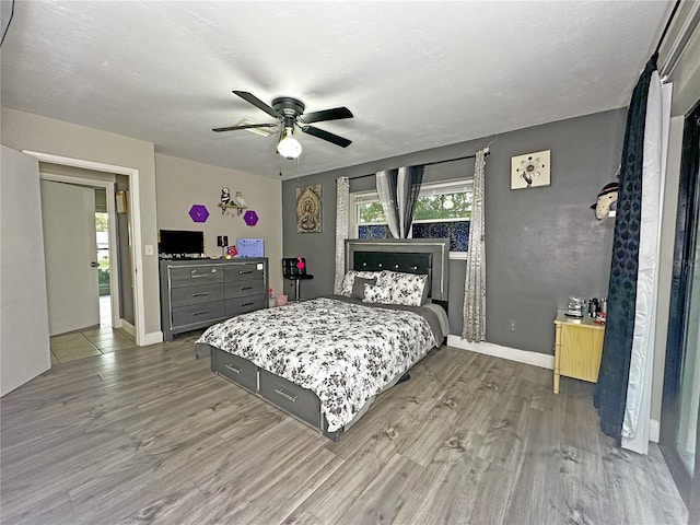 bedroom with hardwood / wood-style floors and ceiling fan