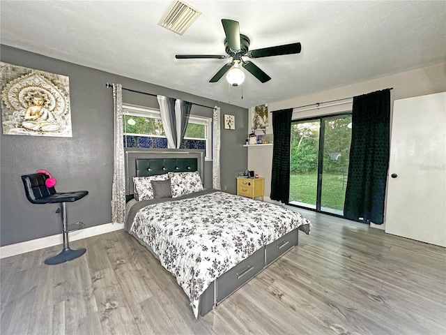 bedroom with access to outside, ceiling fan, and hardwood / wood-style floors