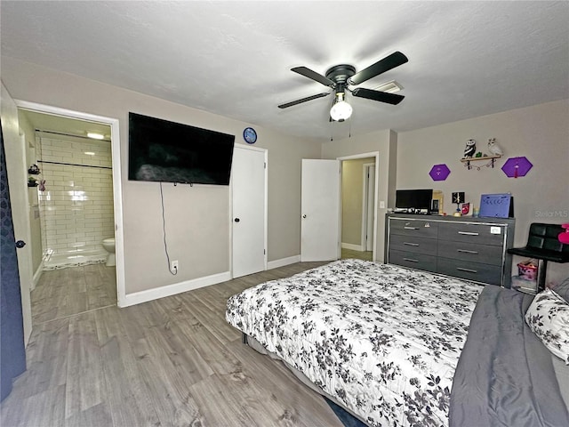 bedroom featuring ensuite bathroom, light hardwood / wood-style flooring, and ceiling fan