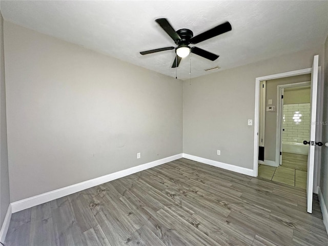 empty room featuring hardwood / wood-style flooring and ceiling fan