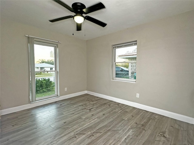 unfurnished room with ceiling fan and wood-type flooring