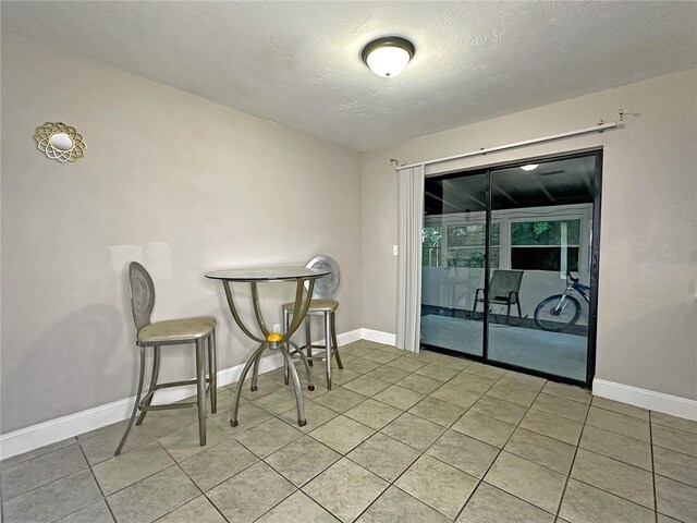1048 Wakefield Cir, Deltona, FL 32725 - dining room with a textured ceiling and light tile patterned floors