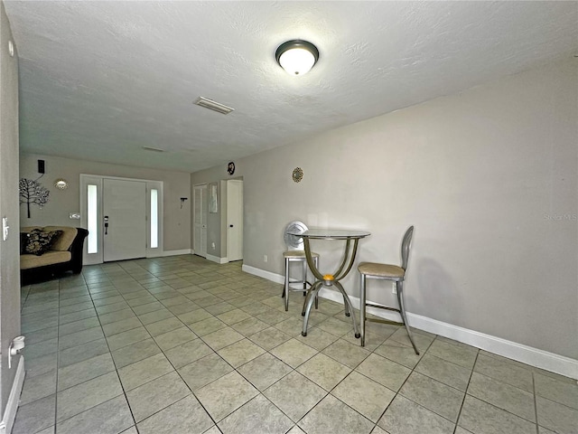 1048 Wakefield Cir, Deltona, FL 32725 - dining room with light tile patterned flooring and a textured ceiling