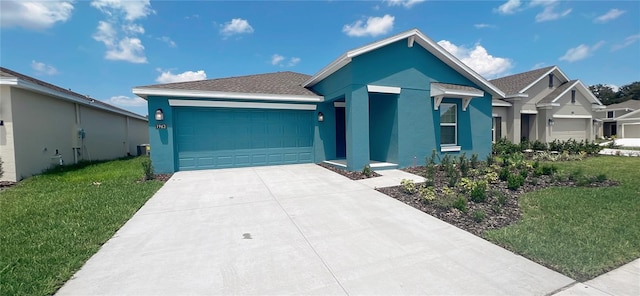 view of front of house featuring a garage and a front lawn