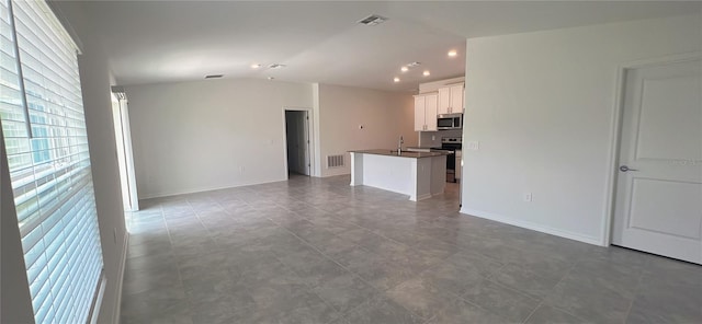 unfurnished living room featuring tile patterned flooring and lofted ceiling