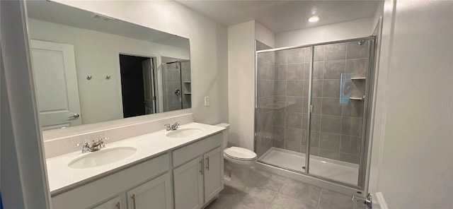 bathroom featuring tile patterned floors, a shower with door, vanity, and toilet