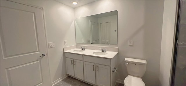 bathroom featuring tile patterned flooring, vanity, and toilet