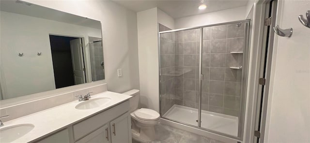 bathroom featuring vanity, toilet, and walk in shower