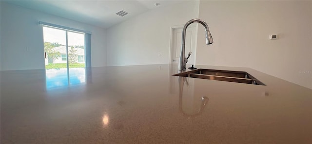 interior space featuring lofted ceiling and sink