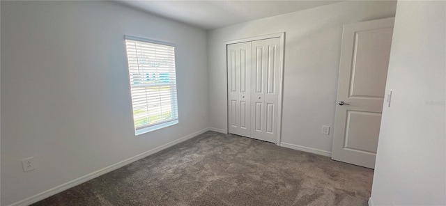 unfurnished bedroom with a closet and carpet floors