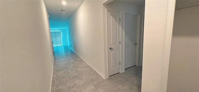 hall featuring light tile patterned floors