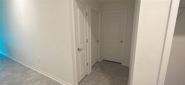 hall featuring light tile patterned floors