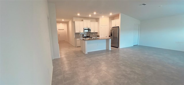 kitchen featuring white cabinetry, a kitchen island, and appliances with stainless steel finishes