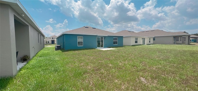 back of house featuring a yard and cooling unit