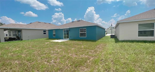 rear view of property with a lawn