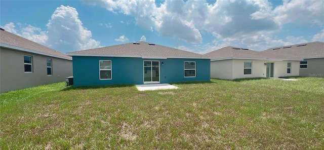 rear view of house with a lawn and cooling unit