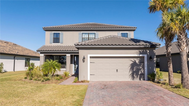 mediterranean / spanish-style house with a garage and a front yard