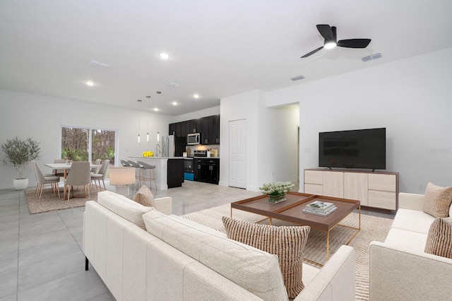 living area with a ceiling fan, light tile patterned flooring, visible vents, and recessed lighting