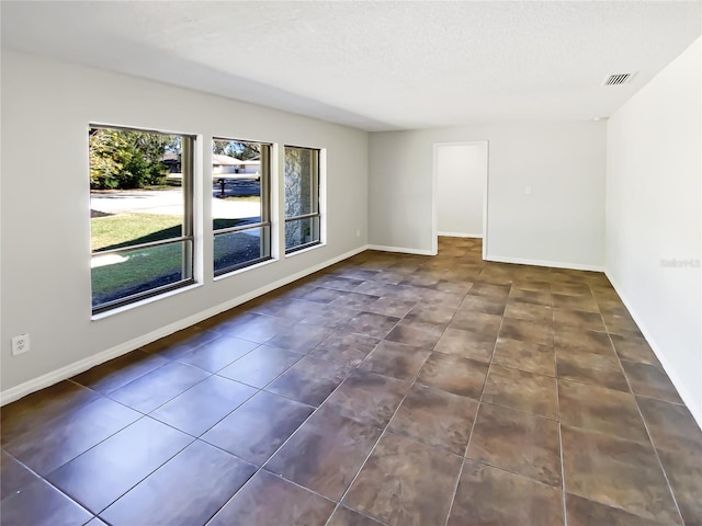 empty room with a textured ceiling