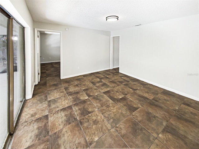 empty room featuring a textured ceiling