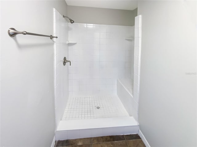 bathroom with tile patterned floors and tiled shower