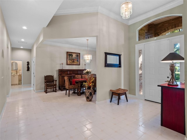 tiled foyer with ornamental molding and a notable chandelier