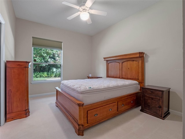 bedroom with ceiling fan and light colored carpet