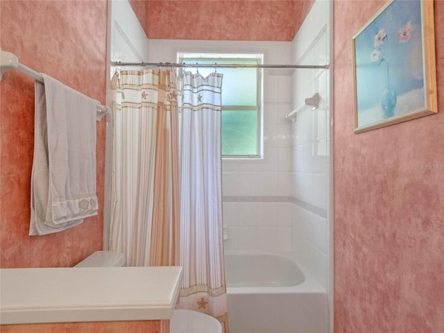 bathroom with shower / bathtub combination with curtain and toilet