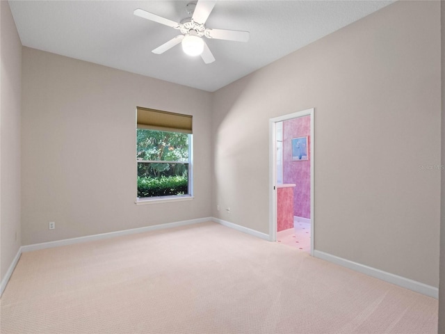 spare room featuring light carpet and ceiling fan