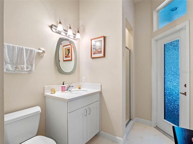 bathroom featuring vanity, toilet, and a shower with shower door