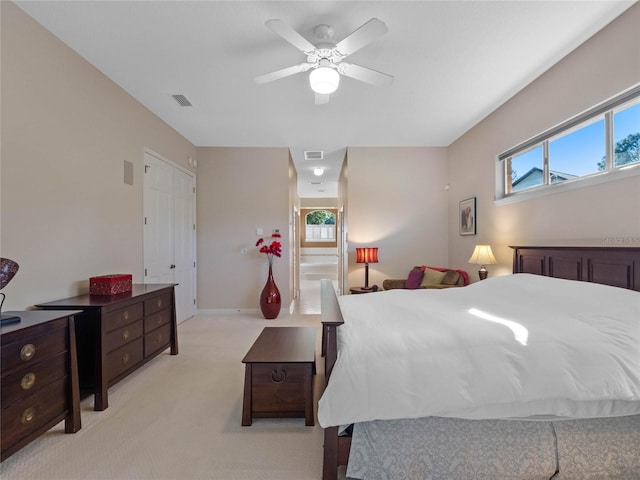 bedroom featuring light carpet and ceiling fan