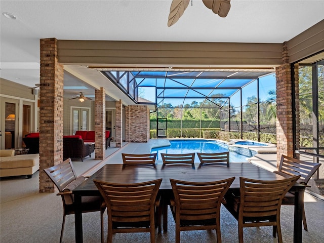 view of patio featuring outdoor lounge area, ceiling fan, a swimming pool with hot tub, and a lanai