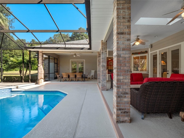 view of pool with french doors, an outdoor hangout area, ceiling fan, a lanai, and a patio