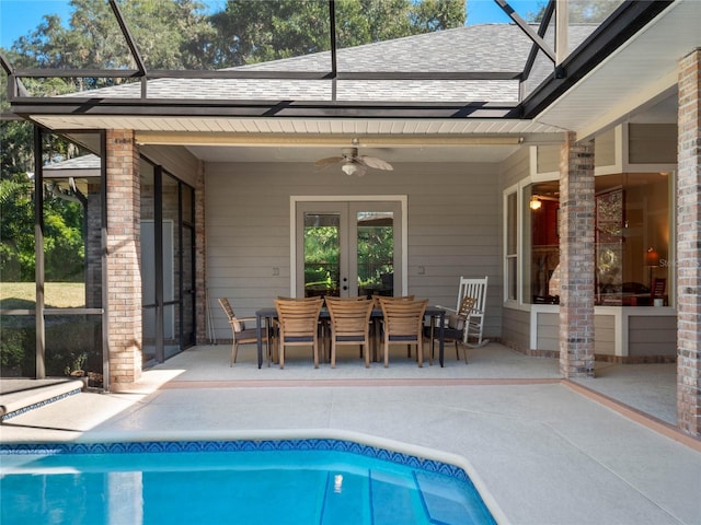 view of swimming pool with french doors, glass enclosure, ceiling fan, and a patio area