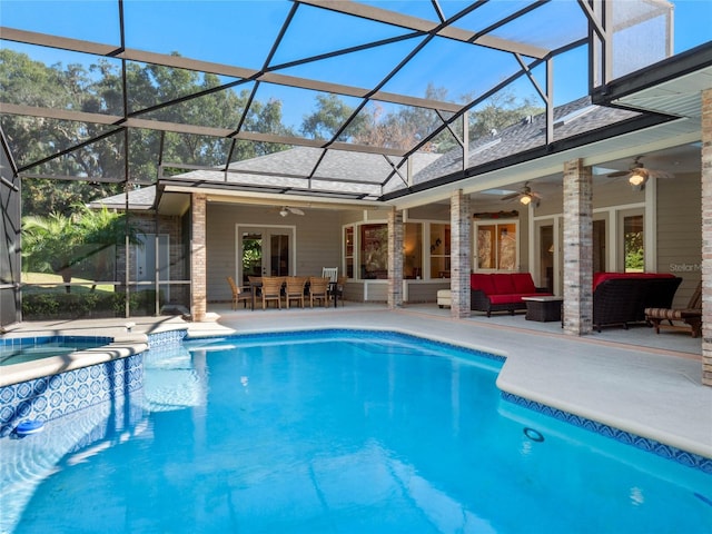 view of pool with ceiling fan, a patio area, an outdoor hangout area, and glass enclosure