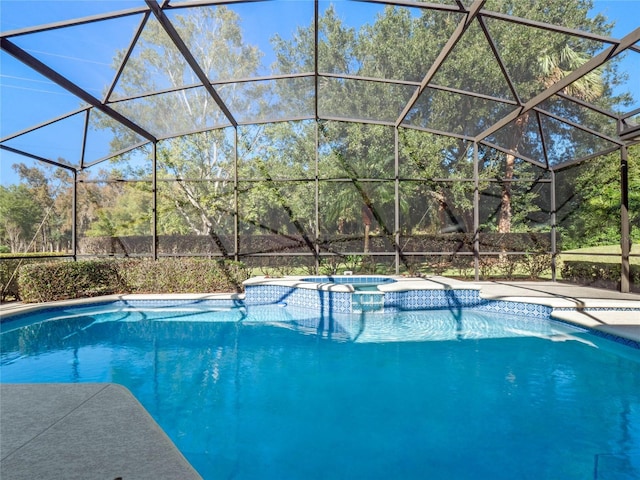 view of swimming pool with a lanai and an in ground hot tub