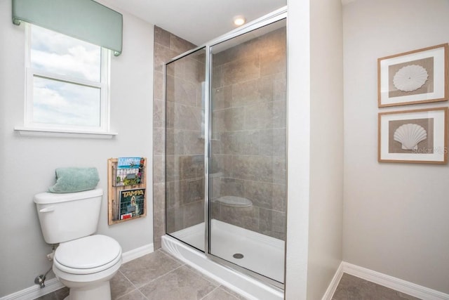 bathroom featuring tile patterned floors, toilet, and an enclosed shower