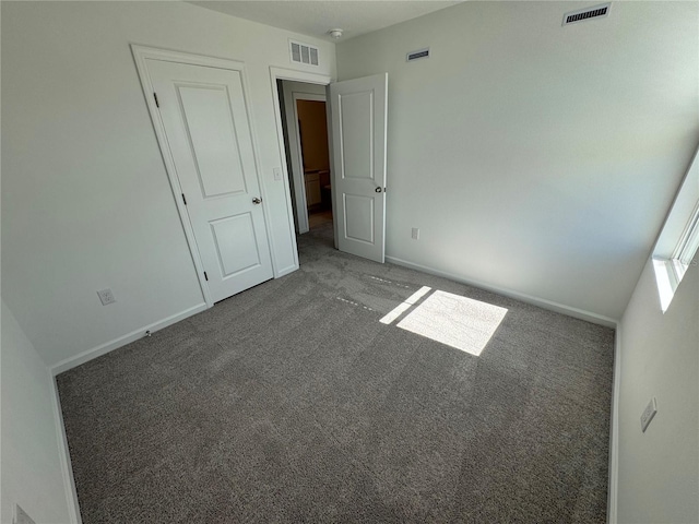 unfurnished bedroom featuring dark colored carpet