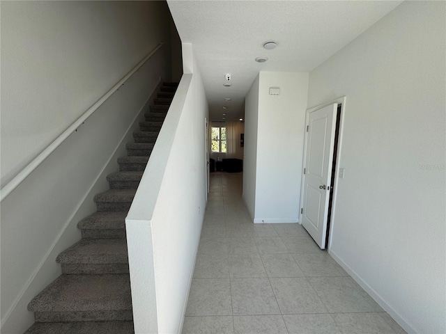 stairway featuring tile patterned flooring